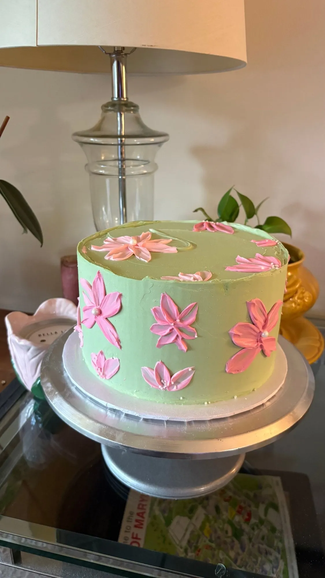 Mint green buttercream cake decorated with pink painted-style buttercream flowers